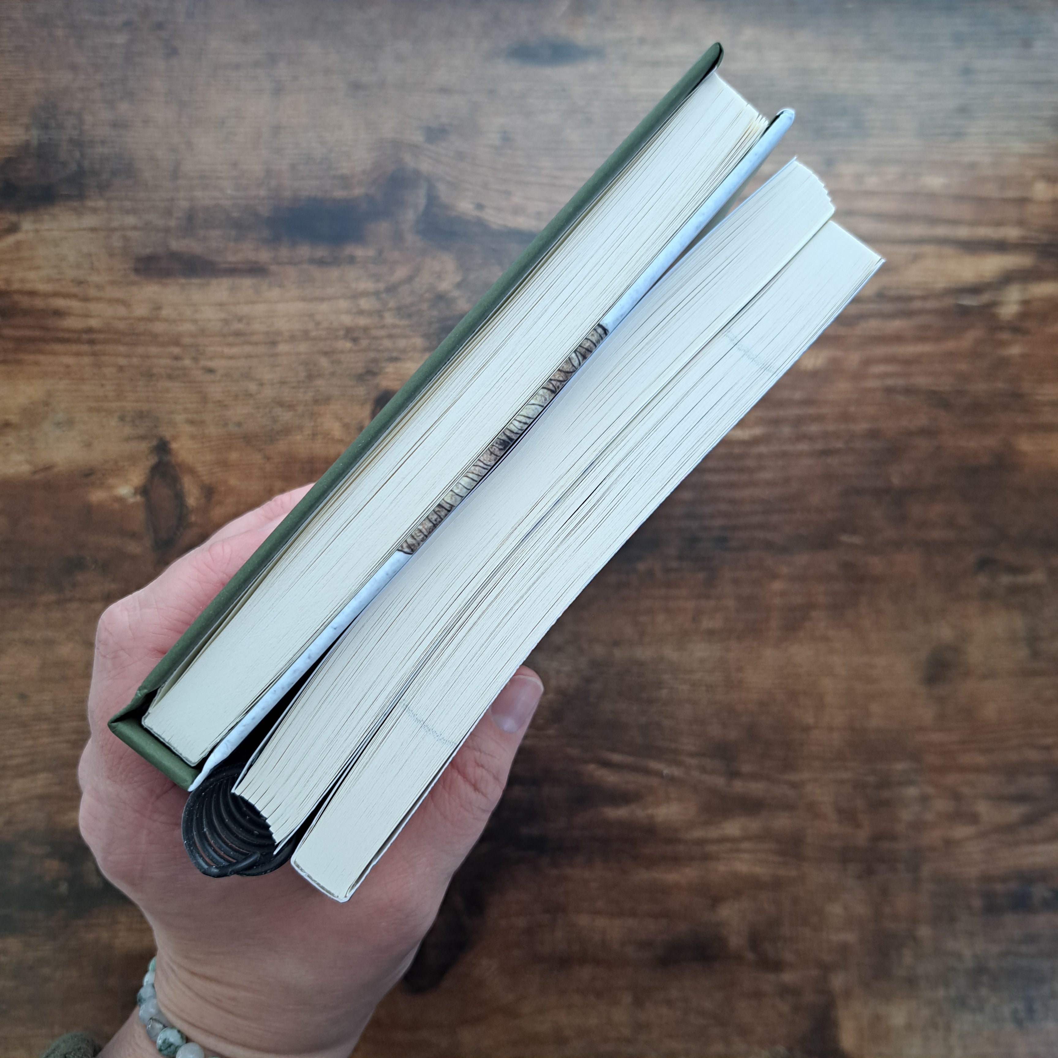 Three Fox Jot Studio journal binding options held in hand — hardcover, softcover, and spiral ring bound — shown from the spine